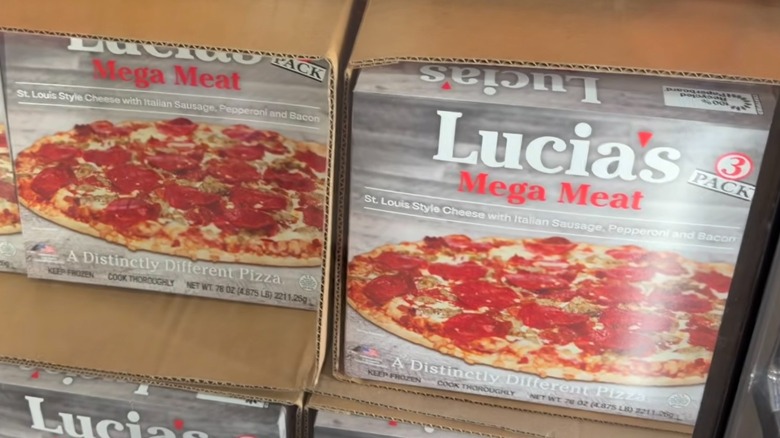 Boxes of Lucias St. Louis Style Mega Meat Pizza inside freezer at Costco store