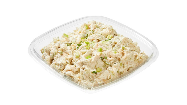 A beauty shot of Kirkland Signature Chicken Salad in a plastic deli tray on a white background
