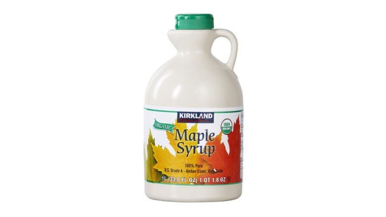 A beauty shot of Kirkland Signature Organic Pure Maple Syrup in plastic jug on a white background