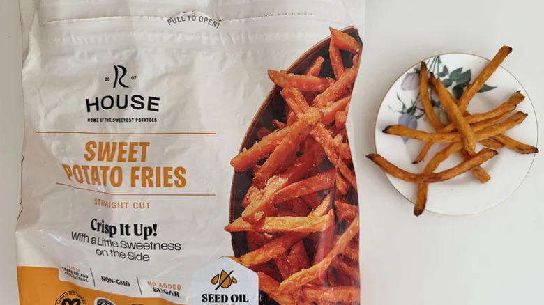 A bag of Russet House Sweet Potato Fries next to a plate of cooked fries