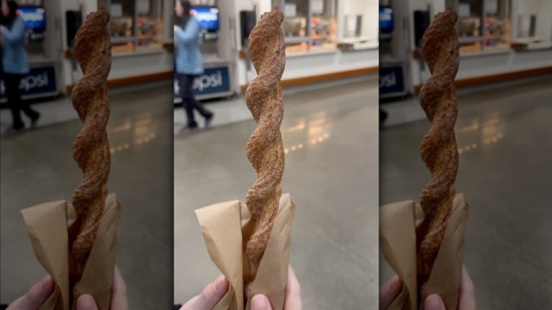 Costco twisted churro in hand outside of food court