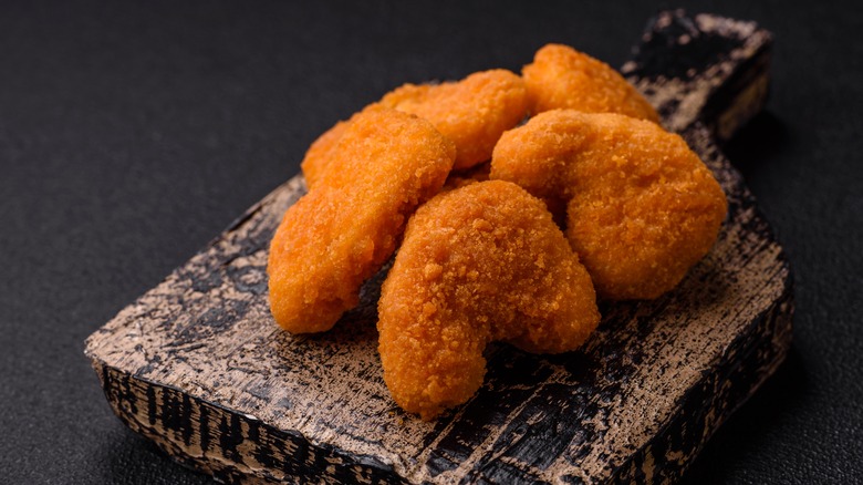 chicken nuggets against dark background