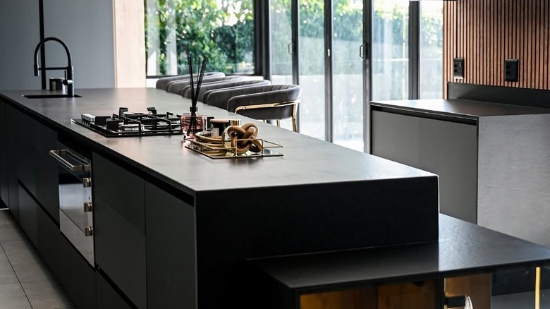 Dark kitchen with bar stools and sliding doors