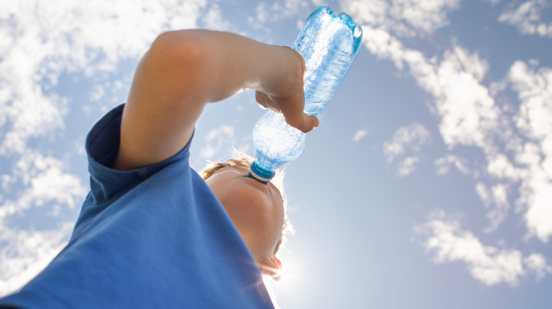 Young boy drinking bottle water