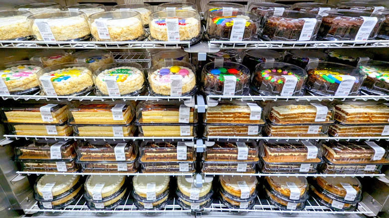shelves of cakes on display inside the Costco store bakery