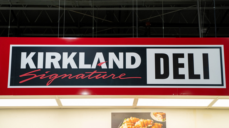 Red signage reading Kirkland Signature Deli inside Costco store