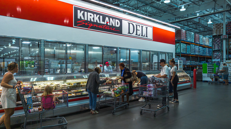 Customers shopping at a Costco deli case
