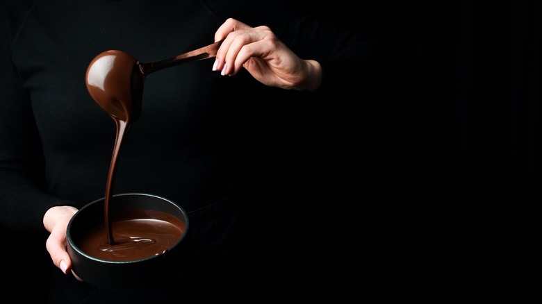 melted chocolate dripping from ladle