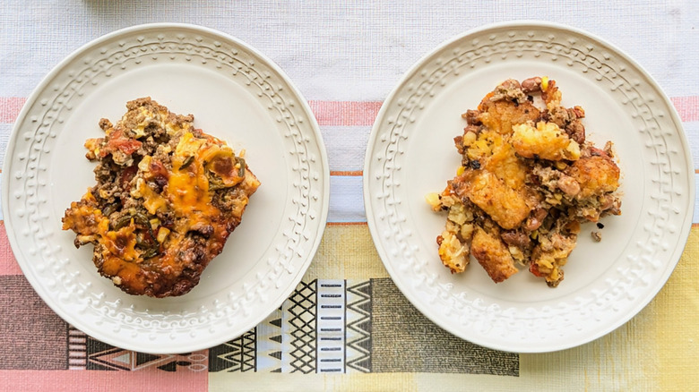 Two plates of cheesy casseroles on tablecloth