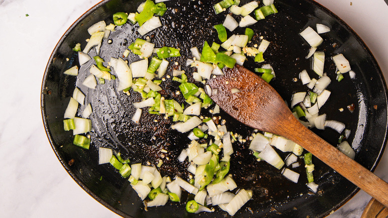 cast iron pan with onions and peppers
