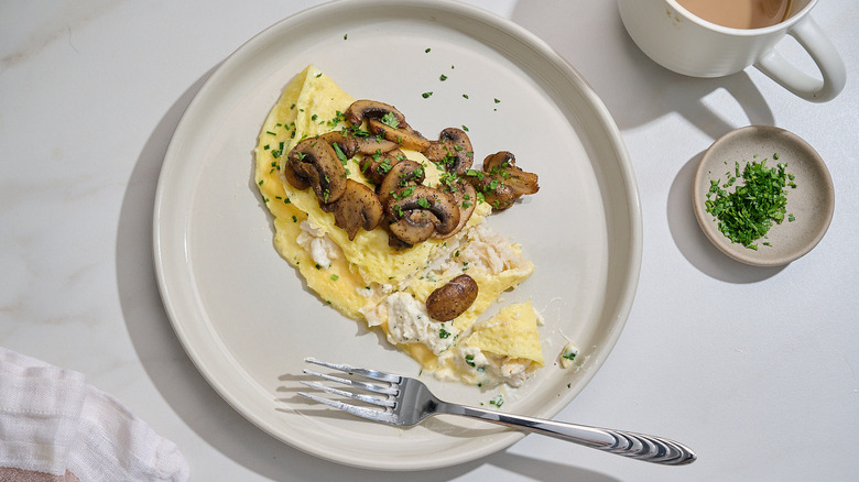 crab and mushroom omelet sliced into on a plate