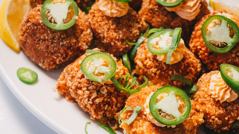 Crab cake jalapeño popper bites on a white platter