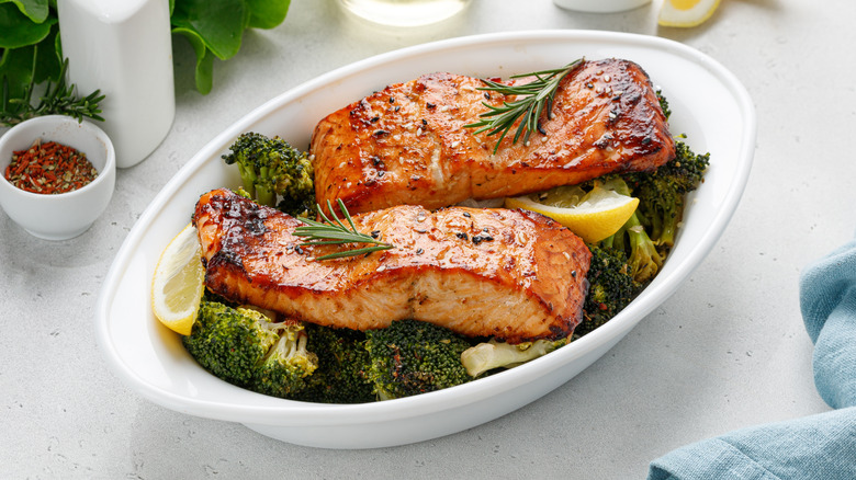 Roasted salmon fillets plated on a bed of broccoli