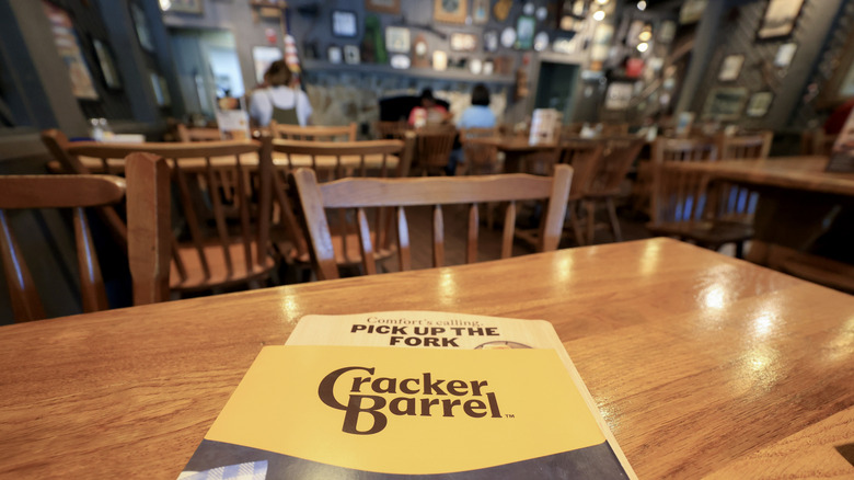 A menu sitting on a table inside a Cracker Barrel restaurant