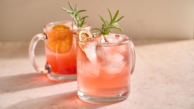 Cranberry cocktails in glass mugs with garnishes