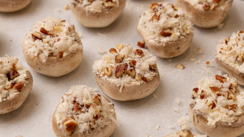 stuffed mushrooms on baking sheet
