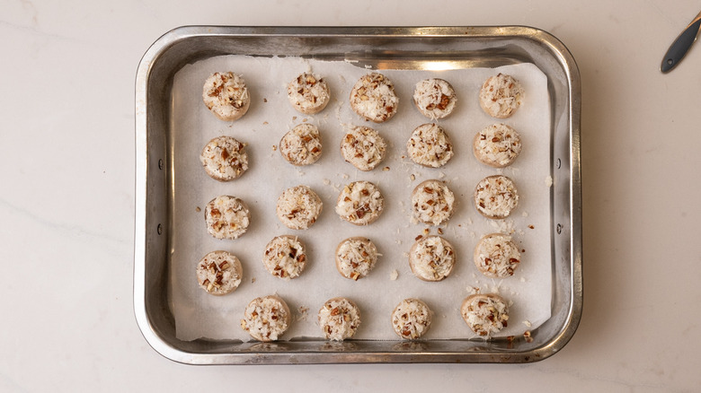 cream cheese stuffed mushrooms on baking sheet