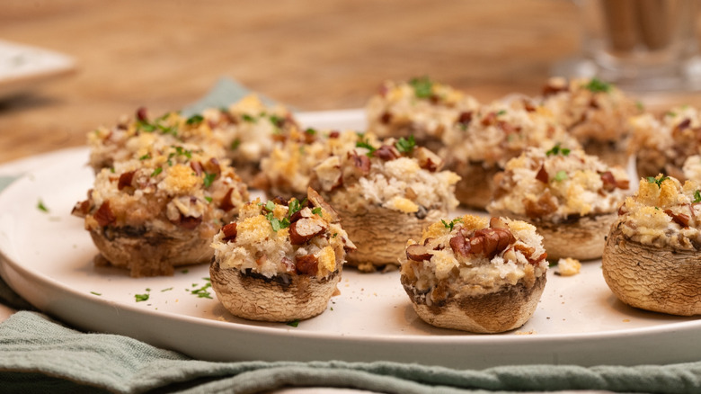 baked cream cheese stuffed mushrooms on serving plate