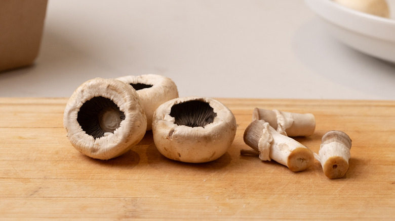 mushrooms with stems removed on cutting board