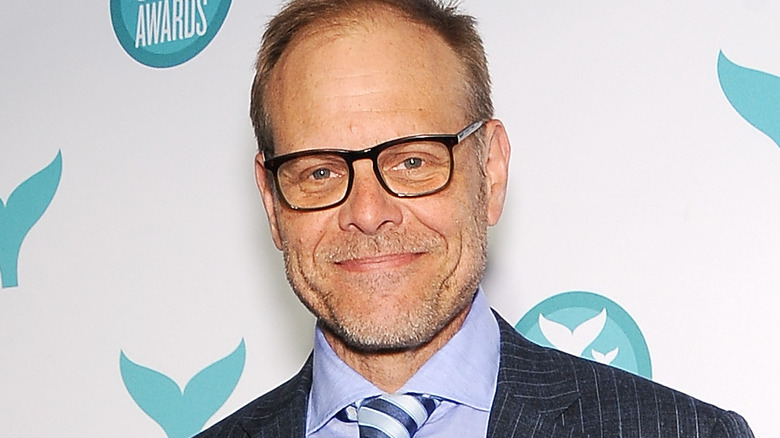 Food star Alton Brown wearing glasses on white background