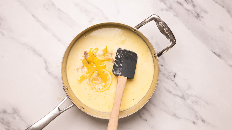 Adding confit lemon to creamy sauce.