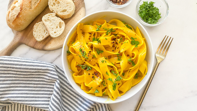 saffron pasta in white bowl