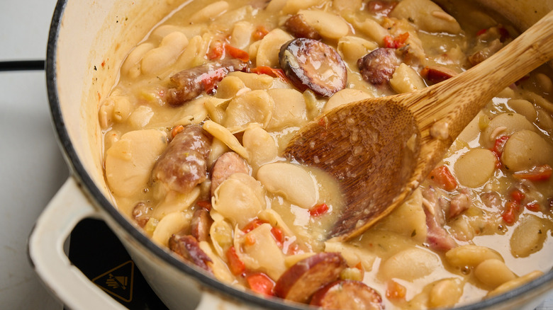 spoon lifting butter beans out of pot