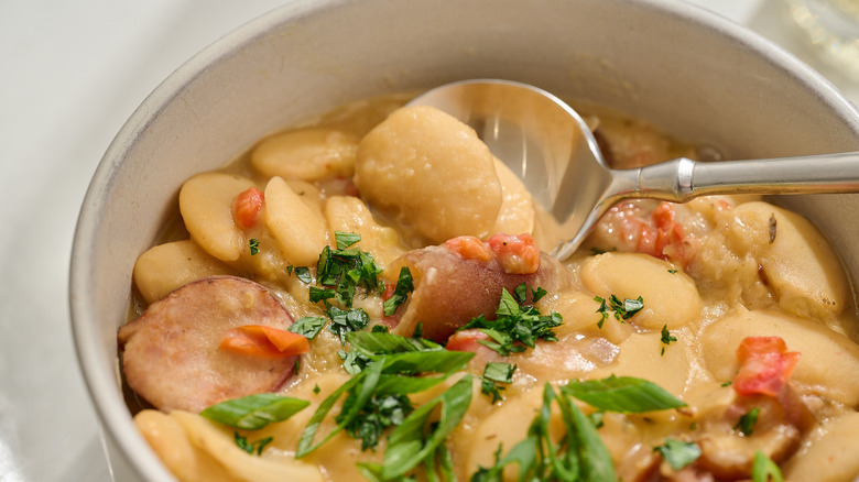 spoon lifting bean out of bowl