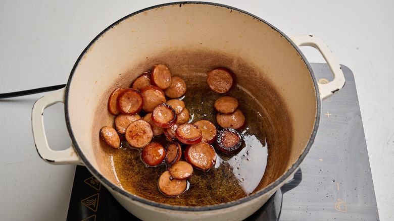 searing sausage in a pot