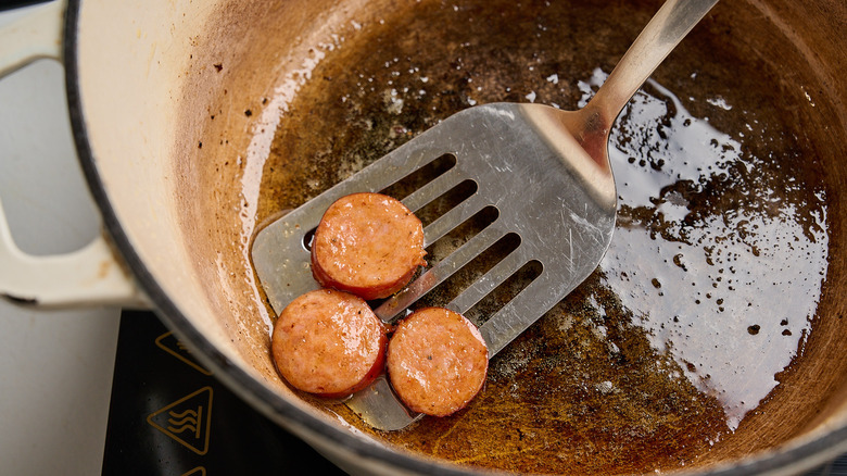 removing sausage from pot