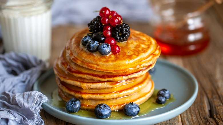 plate of pancakes topped with berries