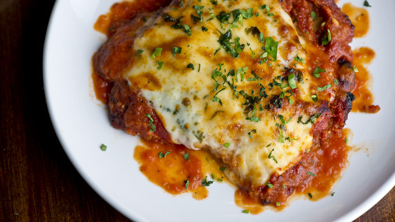 Classic chicken parmesan on a white plate. 