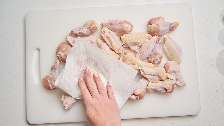 patting wings dry with paper towel