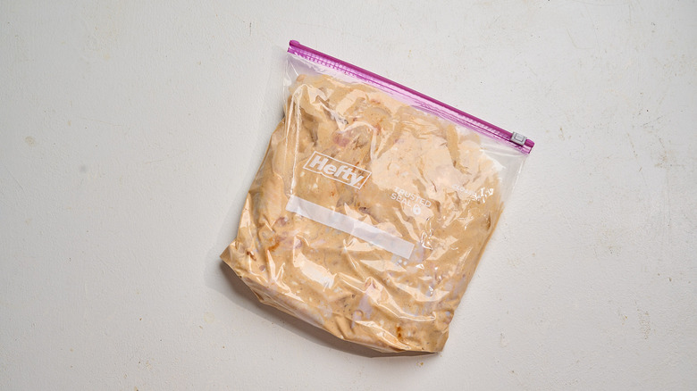 chicken marinating in a bag