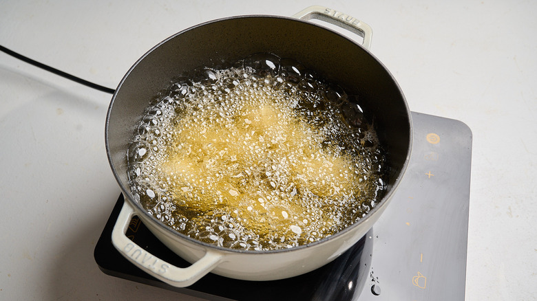 wings frying in a pot of hot oil