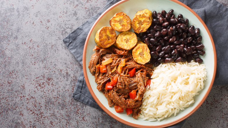 typical criollo Venezolano with plantains, beans, rice, and pork