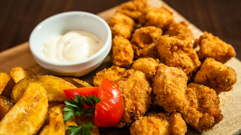 Crispy looking fried chicken with fries and sauce