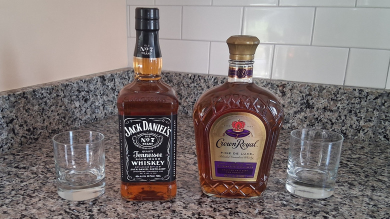 bottles of Crown Royal and Jack Daniel's with glasses on counter displayed