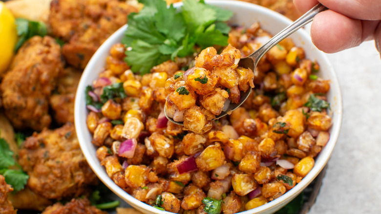 Crunchy tangy masala corn with spoon