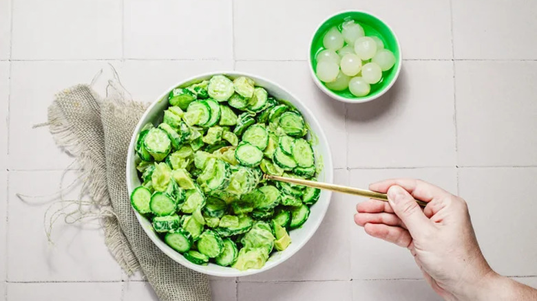 Cucumber salad in a bowl with pearl onions