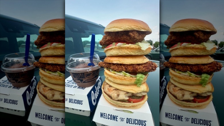 Two fried chicken sandwiches on top of one another and a Culver's concrete mixer on the side