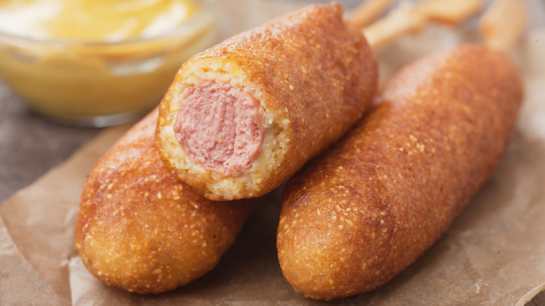 Corn Dogs stacked together on brown paper