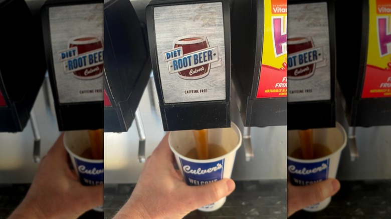 Mirrored image, close up of hand filling up cup with diet root beer at machine