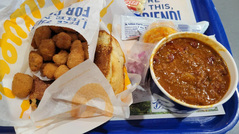 A portion of George's Chili Supreme from Culver's, accompanied by a grilled cheese sandwich and Wisconsin Cheese Curds