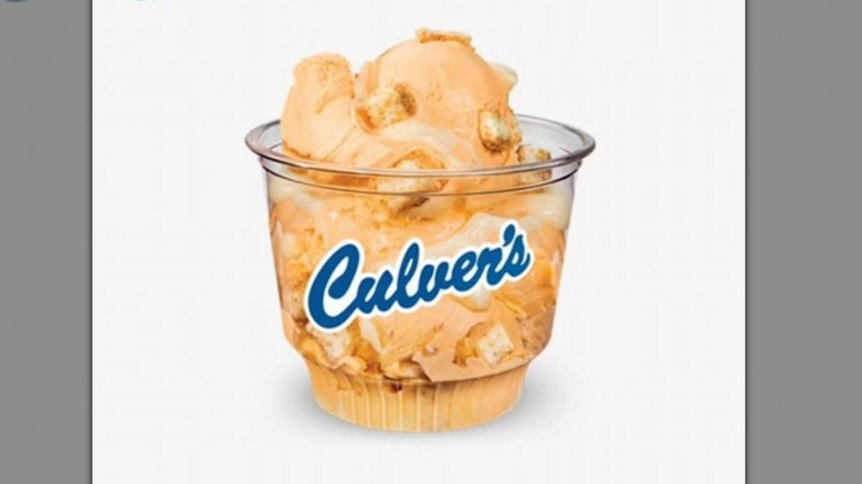 Cup of Orange Creamsicle frozen custard from Culver's with blue restaurant logo