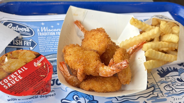 A Culver's fried shrimp value basket with cocktail sauce, shrimp, and fries sits on a tray
