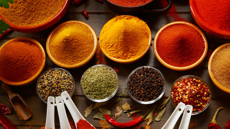 Several bowls piled high with brightly-colored spices