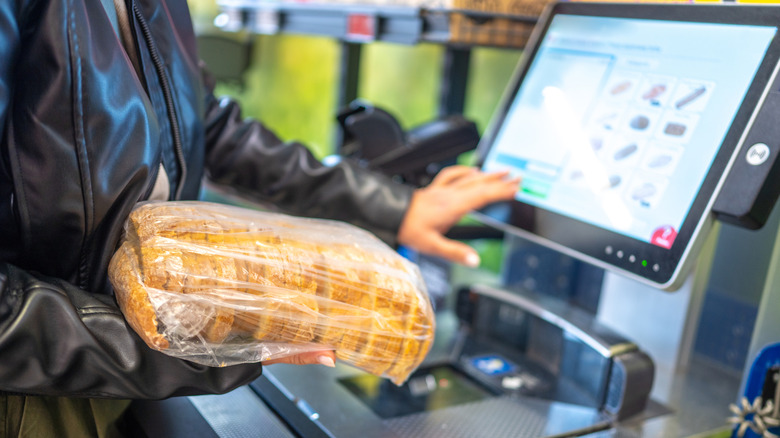 Person scanning groceries at self-checkout