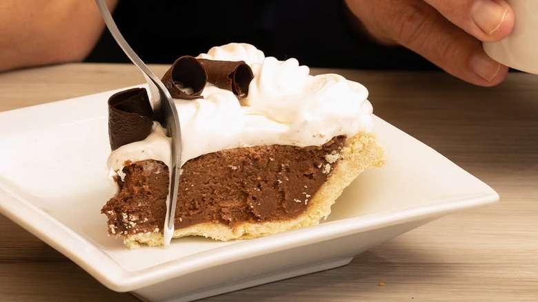 Chocolate and cream layered pie with fork