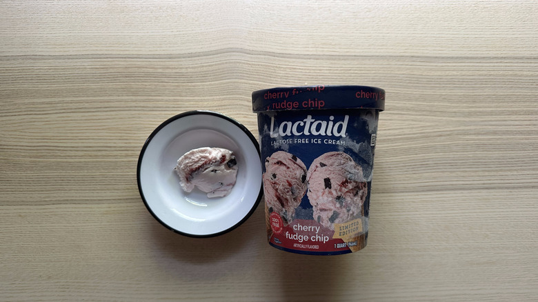 tub of Lactaid cherry fudge chip and a scoop in a bowl